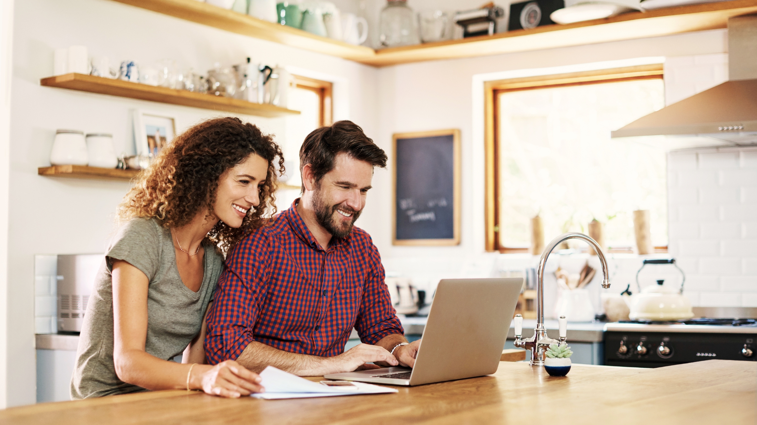 man and woman in front of laptop
